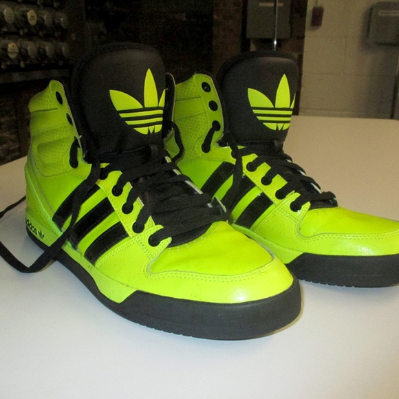 black and yellow adidas high tops